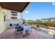 Charming outdoor patio with waterfront views, dining table, blue accents and lush foliage at 4740 Beach Se Dr # A, St Petersburg, FL 33705