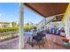 Charming outdoor patio with waterfront views, dining table, blue accents and lush foliage at 4740 Beach Se Dr # A, St Petersburg, FL 33705