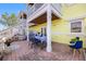 Charming outdoor patio with waterfront views, dining table, blue accents and lush foliage at 4740 Beach Se Dr # A, St Petersburg, FL 33705