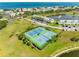 Overview of well-maintained tennis courts within a waterfront community, with nearby condos and a pond at 4740 Beach Se Dr # A, St Petersburg, FL 33705