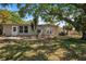 Exterior view of the house showing a patio and a spacious backyard, perfect for outdoor activities at 4790 Shore Acres Ne Blvd, St Petersburg, FL 33703