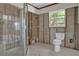 Bathroom featuring a walk-in shower and bright window offering natural light at 4790 Shore Acres Ne Blvd, St Petersburg, FL 33703