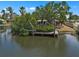 View from the water featuring a private dock and lush landscaping, a perfect spot for relaxation at 4790 Shore Acres Ne Blvd, St Petersburg, FL 33703