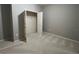 A bedroom featuring light carpet and gray walls with an open closet with a single rod at 5221 Bannister Park Ln, Lithia, FL 33547