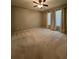 Expansive bedroom featuring soft carpet flooring, neutral paint, and abundant natural light from windows at 5221 Bannister Park Ln, Lithia, FL 33547