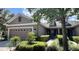 Charming single-Gathering home with a manicured lawn and two car garage under a blue sky at 5221 Bannister Park Ln, Lithia, FL 33547