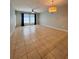 Spacious living room featuring tile floors, ample natural light, and contemporary lighting fixtures at 5221 Bannister Park Ln, Lithia, FL 33547