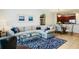 Cozy living room with sectional sofa and glass coffee table, that opens to a dining space and kitchen at 5221 Bannister Park Ln, Lithia, FL 33547