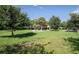 Scenic park area featuring lush green grass, mature trees, and a charming gazebo in the background at 5221 Bannister Park Ln, Lithia, FL 33547