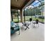Inviting screened patio with cozy seating, ideal for relaxing and enjoying outdoor living at 5221 Bannister Park Ln, Lithia, FL 33547