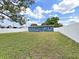 Large fenced backyard with a large shade tree and ample space for various activities at 5772 4Th N Ave, St Petersburg, FL 33710