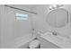Bright bathroom featuring white subway tile, updated vanity, and tub with shower at 5772 4Th N Ave, St Petersburg, FL 33710