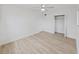 Spacious bedroom featuring light-colored vinyl floors, a ceiling fan, and closet storage at 5772 4Th N Ave, St Petersburg, FL 33710
