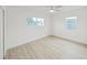 Bright bedroom with light-colored vinyl flooring, two windows, and white trim at 5772 4Th N Ave, St Petersburg, FL 33710