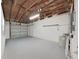 Spacious garage featuring a roll up door, ample space, and a painted floor at 5772 4Th N Ave, St Petersburg, FL 33710