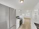 Open concept kitchen with stainless steel appliances and a view into the dining and living space at 5772 4Th N Ave, St Petersburg, FL 33710
