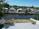 Waterfront property featuring a house with a dock and boat lift on a sunny day at 5812 Liverpool Dr, Tampa, FL 33615
