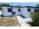 View of the home's backyard showing concrete, an A/C unit, and small garden at 5812 Liverpool Dr, Tampa, FL 33615