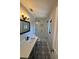 Bathroom showcasing modern vanity, glass shower, and decorative tile at 5812 Liverpool Dr, Tampa, FL 33615