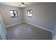This bedroom features hard floors, a ceiling fan, and two black-framed windows at 5812 Liverpool Dr, Tampa, FL 33615