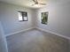 This bedroom features hard floors, a ceiling fan, and two black-framed windows at 5812 Liverpool Dr, Tampa, FL 33615