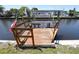 Wooden boat lift on a sunny day with an American flag and canal homes in the background at 5812 Liverpool Dr, Tampa, FL 33615