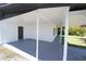 View under the carport showcasing ample space, leading to a well-maintained home at 5812 Liverpool Dr, Tampa, FL 33615