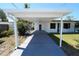 View of the spacious carport with a well-maintained driveway, and a charming home entrance at 5812 Liverpool Dr, Tampa, FL 33615