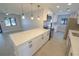 Open kitchen with a quartz island, stainless appliances, and seamless transition into the living area at 5812 Liverpool Dr, Tampa, FL 33615