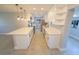 Spacious kitchen island with quartz countertops, stainless appliances, and modern white cabinetry at 5812 Liverpool Dr, Tampa, FL 33615