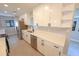 Well-lit kitchen featuring quartz countertops, stainless steel appliances, and modern white cabinetry at 5812 Liverpool Dr, Tampa, FL 33615