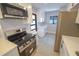 Modern kitchen with stainless steel appliances, sleek cabinetry, and stylish countertops at 5812 Liverpool Dr, Tampa, FL 33615