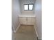 Small laundry area with white cabinets, quartz countertops, and a window at 5812 Liverpool Dr, Tampa, FL 33615