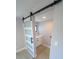 Laundry room with a sliding barn door and modern cabinets featuring quartz counters at 5812 Liverpool Dr, Tampa, FL 33615