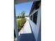 Side yard featuring a narrow walkway and flower garden at 5812 Liverpool Dr, Tampa, FL 33615