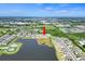 Aerial view of homes in a neighborhood setting with a large lake in the community at 582 Royal Empress Dr, Ruskin, FL 33570