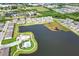 Beautiful aerial view of the community with pool, lake, and lush landscaping at 582 Royal Empress Dr, Ruskin, FL 33570