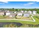 An aerial view of a residential neighborhood near a lake and walking path at 582 Royal Empress Dr, Ruskin, FL 33570