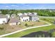 An aerial view of the community homes, a lake, and a sidewalk at 582 Royal Empress Dr, Ruskin, FL 33570
