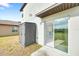 Home exterior featuring a sliding glass door with kitchen view and storage shed in the backyard at 582 Royal Empress Dr, Ruskin, FL 33570