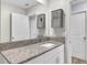 Bathroom featuring granite countertops, vanity cabinet, and storage cabinets at 582 Royal Empress Dr, Ruskin, FL 33570