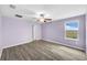 Large bedroom with wood flooring, neutral walls, ceiling fan, and a window with a scenic view at 582 Royal Empress Dr, Ruskin, FL 33570
