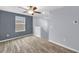 Bedroom with a large window letting in natural light, ceiling fan, and neutral paint scheme at 582 Royal Empress Dr, Ruskin, FL 33570