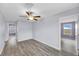 The spacious bedroom boasts sleek wood flooring, complemented by calming gray walls and ample natural light at 582 Royal Empress Dr, Ruskin, FL 33570