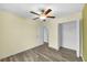 Bedroom featuring wood-look floors, closet, ceiling fan, and light yellow walls at 582 Royal Empress Dr, Ruskin, FL 33570