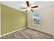 Bedroom with wood-look flooring, ceiling fan, and window with a view of the neighborhood at 582 Royal Empress Dr, Ruskin, FL 33570