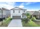 Two-story home with a two-car garage, manicured lawn and tasteful landscaping at 582 Royal Empress Dr, Ruskin, FL 33570