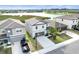Bright two-story home with a two-car garage, extended driveway with water views in the background at 582 Royal Empress Dr, Ruskin, FL 33570