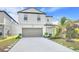 Beautiful two-story home with a two-car garage, long driveway, and meticulously maintained front lawn with landscaping at 582 Royal Empress Dr, Ruskin, FL 33570