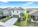 Charming two-story home with a two-car garage, extended driveway and partial water view at 582 Royal Empress Dr, Ruskin, FL 33570
